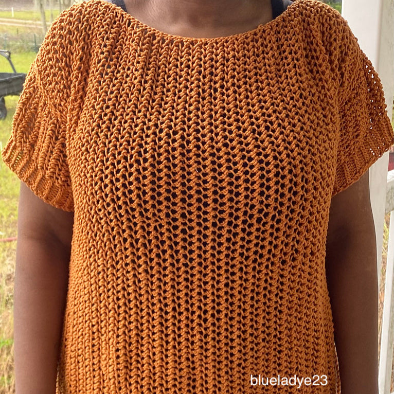 Close-up of a woman wearing the Halcyon Lace Sweater in a rich copper color