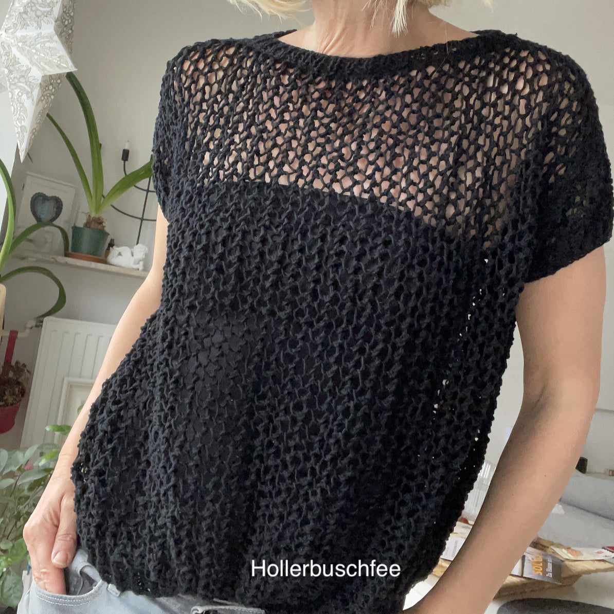 Close-up of a woman wearing the Halcyon Lace Sweater in black