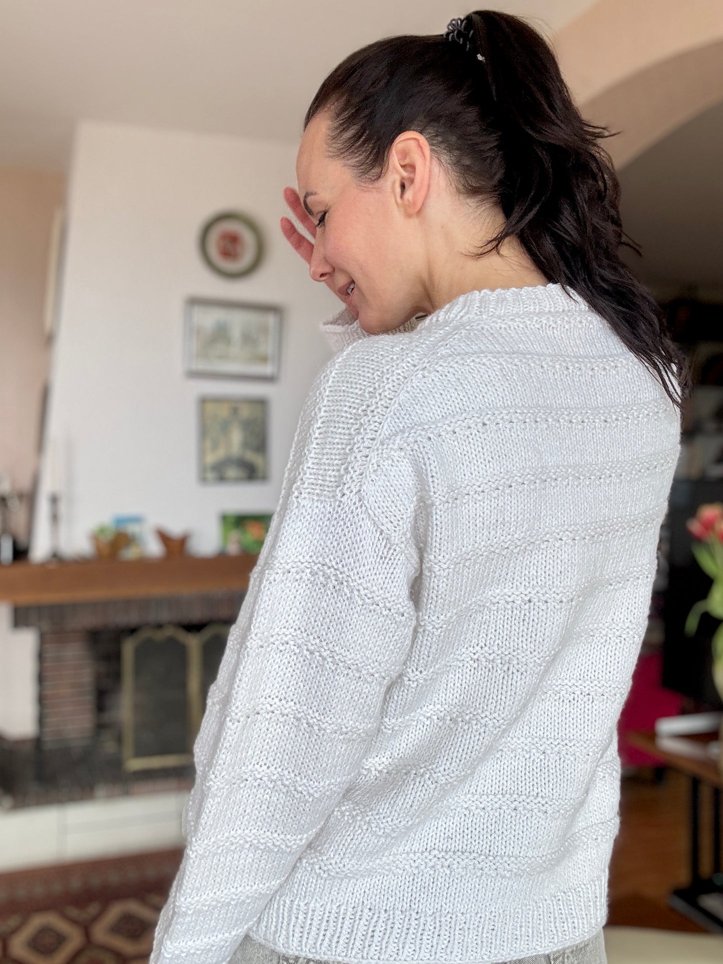 Julia Piro modeling The Artist’s Sweater in cream, featuring a relaxed fit and horizontal textured details.