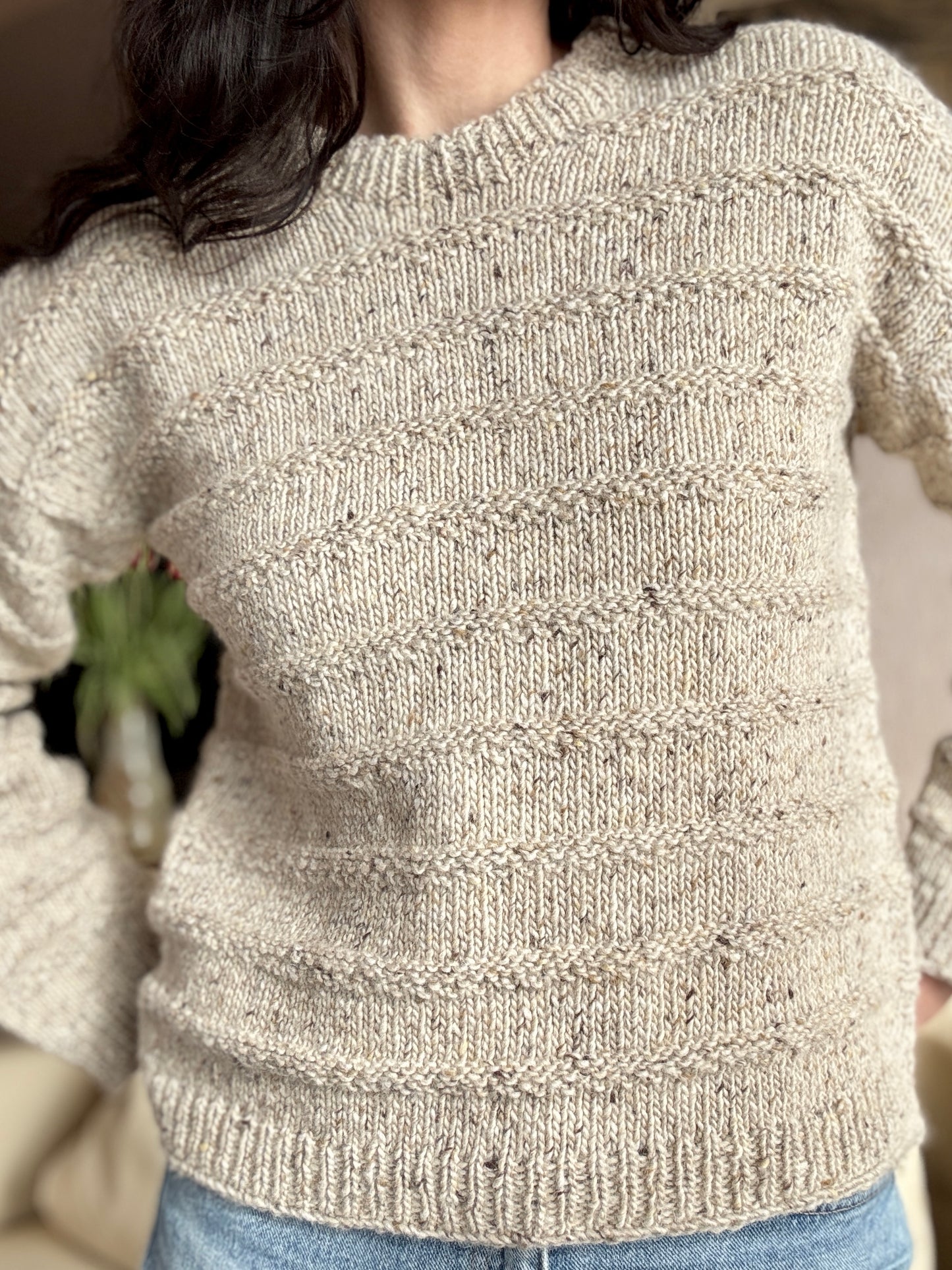 Woman wearing The Artist’s Sweater in a beige.