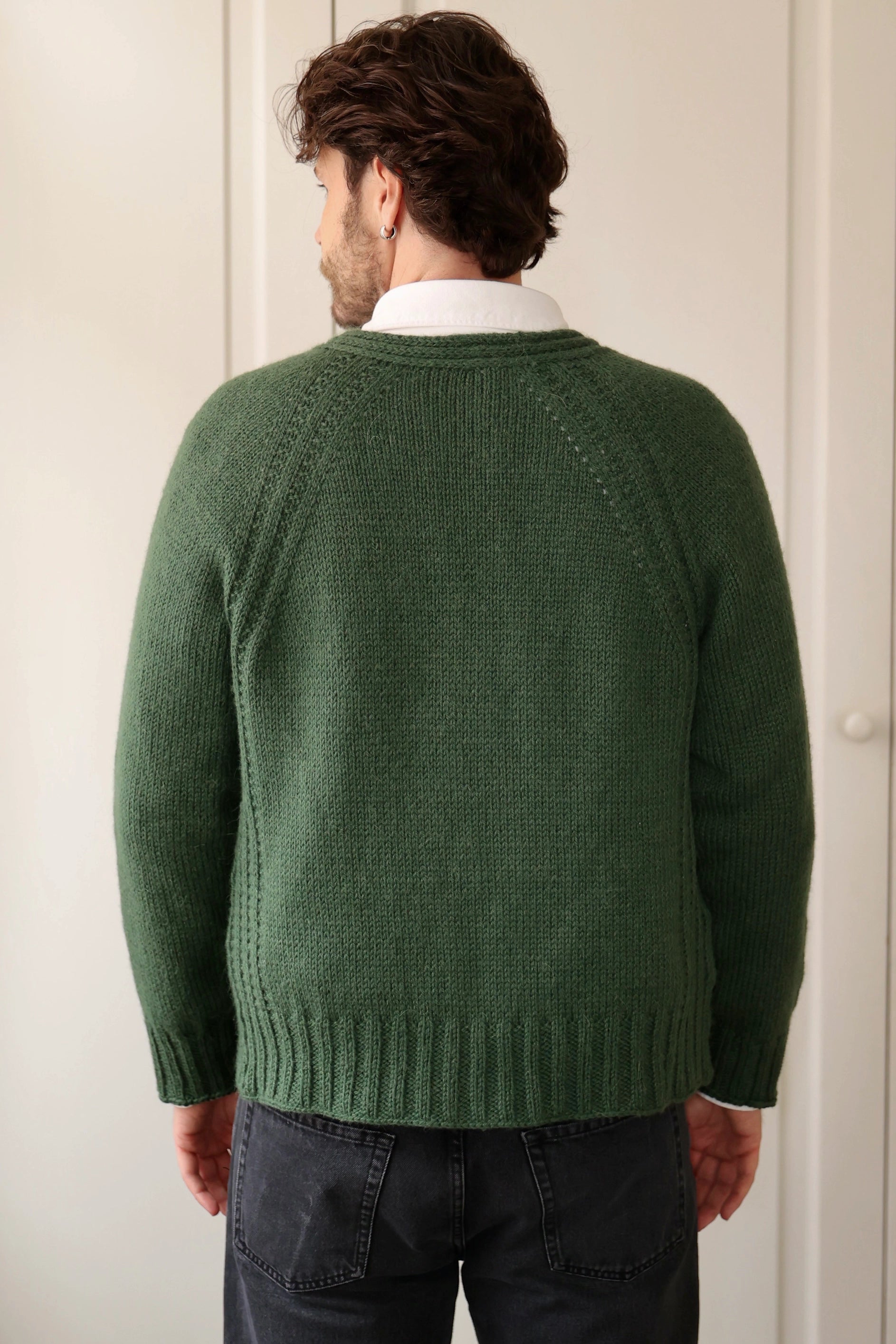 Back view of a man wearing the Mellow Mood Cardigan in forest green