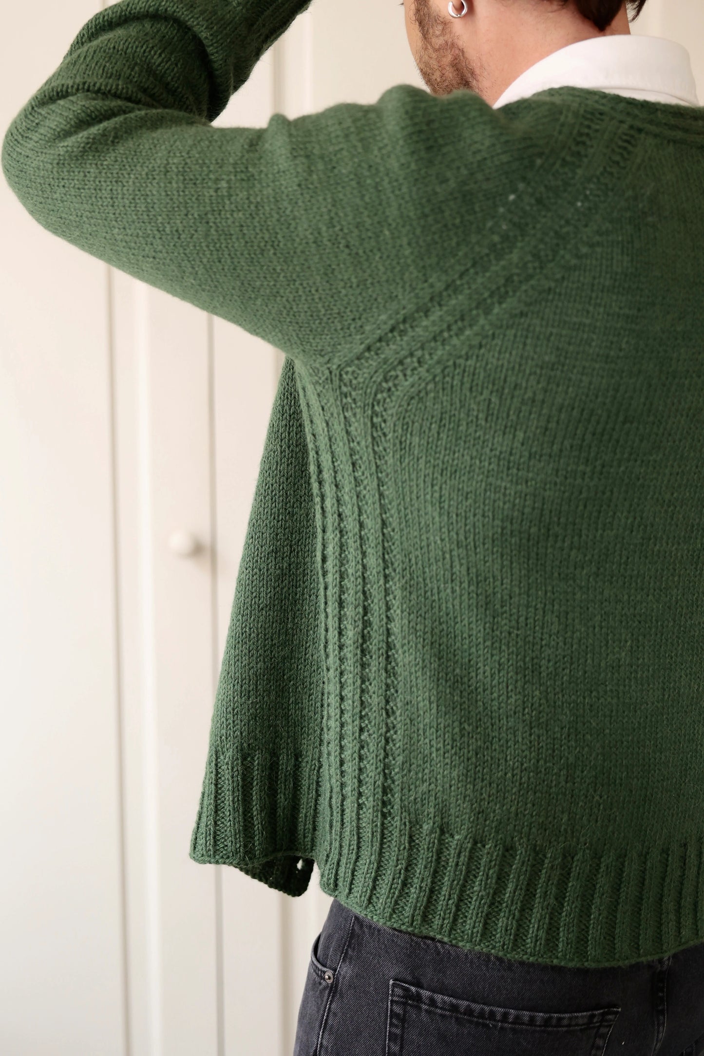 Back view of a man wearing the Mellow Mood Cardigan in forest green