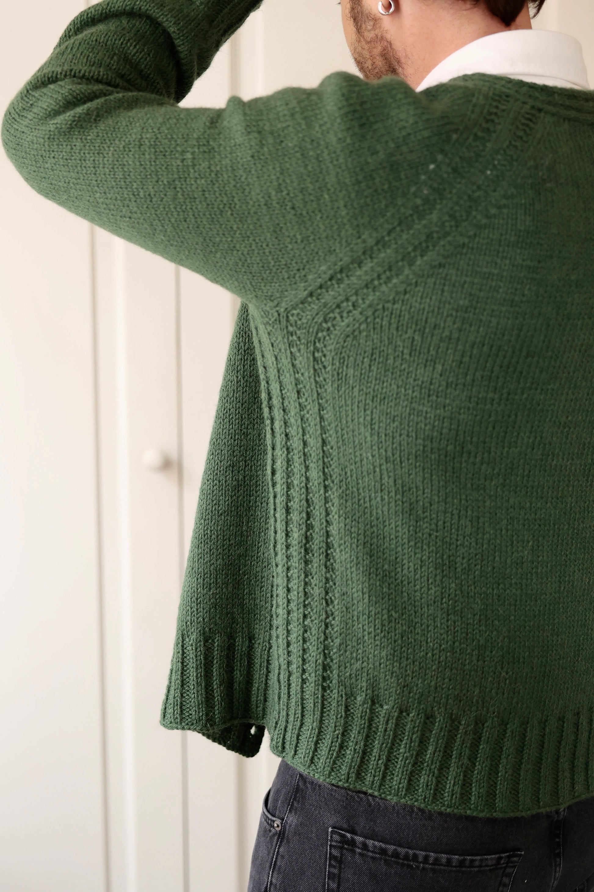 Back view of a man wearing the Mellow Mood Cardigan in forest green