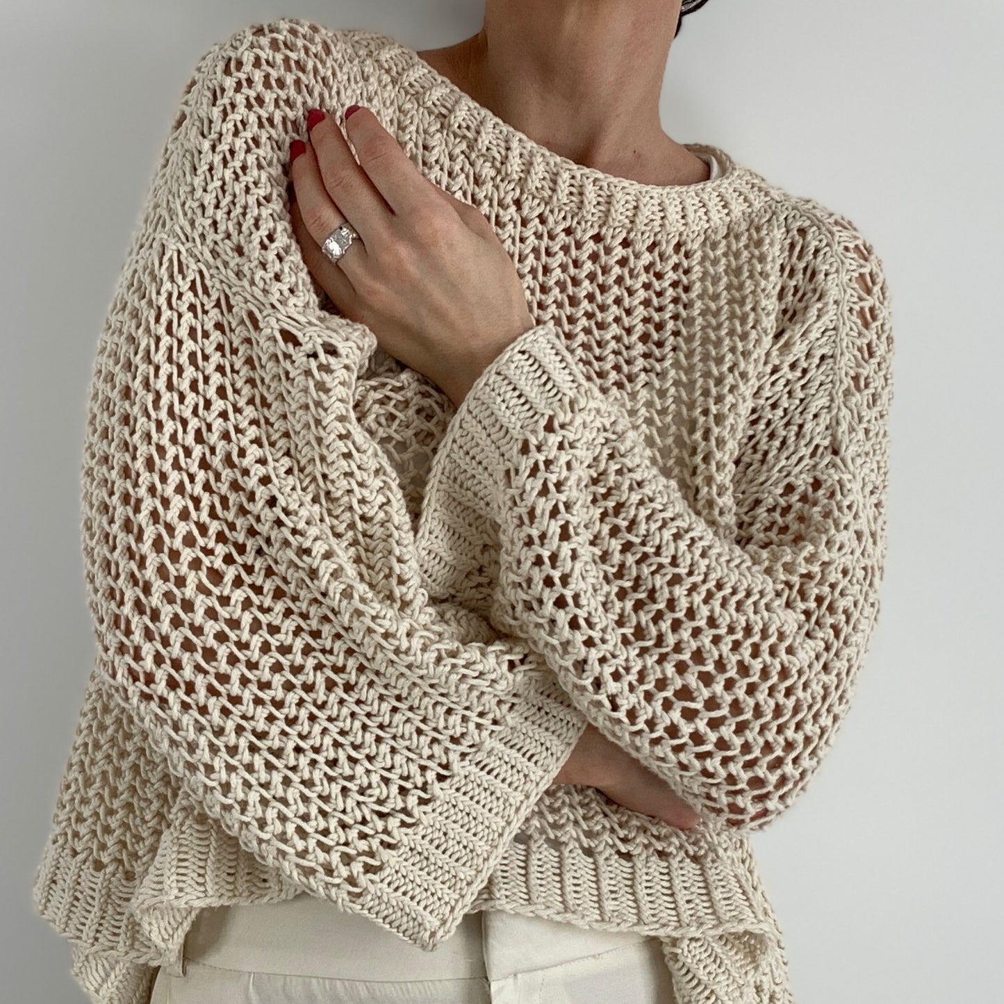 Close-up of a woman wearing the Halycon Sweater
