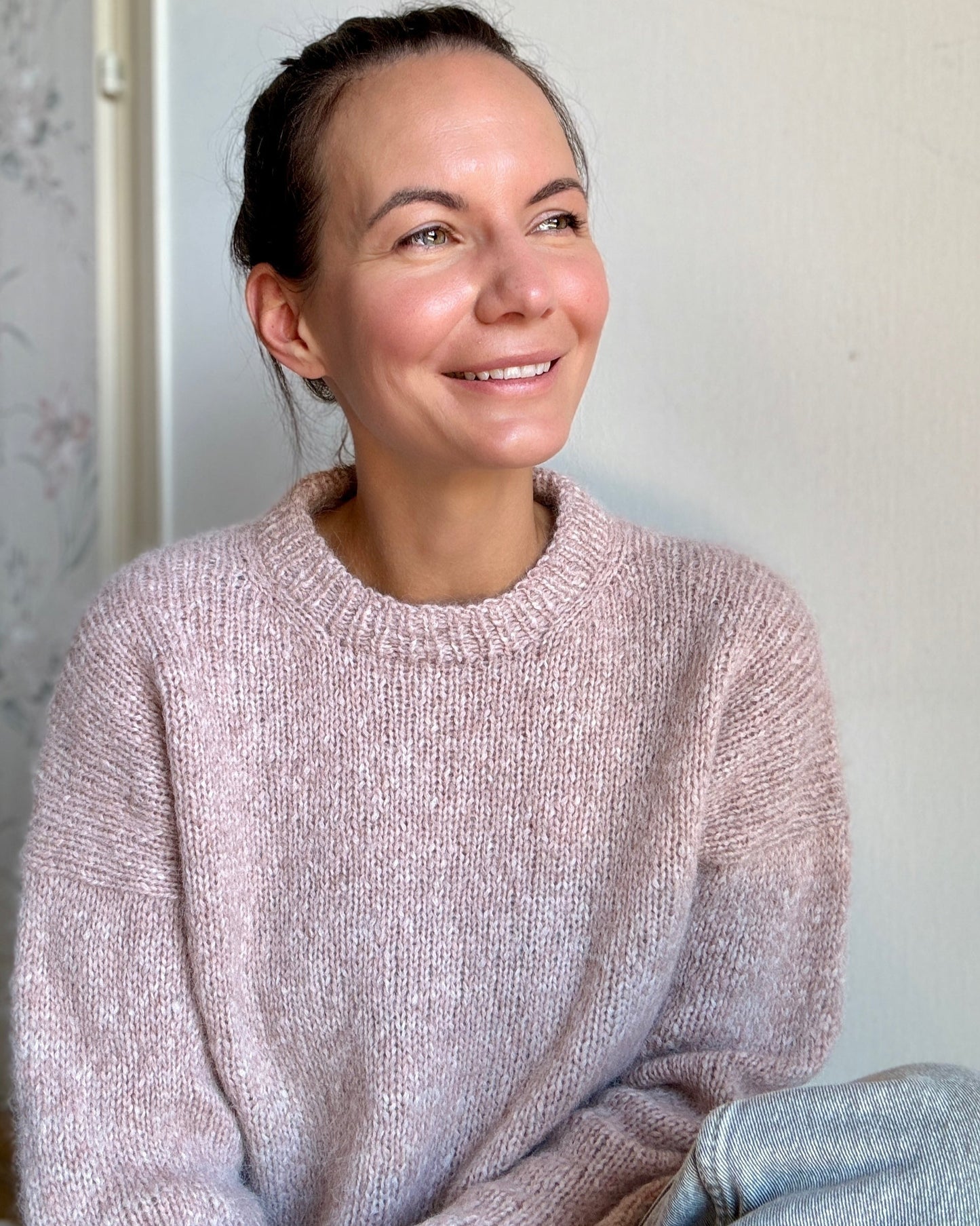 Julia Piro smiling while wearing the Drop in Dream sweater in pink.