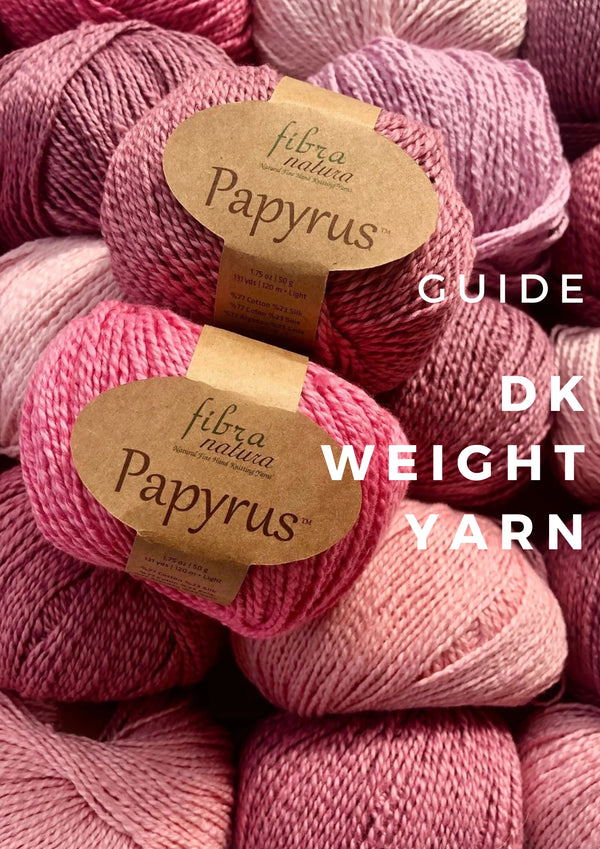 A cover image for the DK Weight Yarn Guide featuring two skeins of Fibra Natura Papyrus yarn in soft pink tones stacked among other yarns in similar shades.